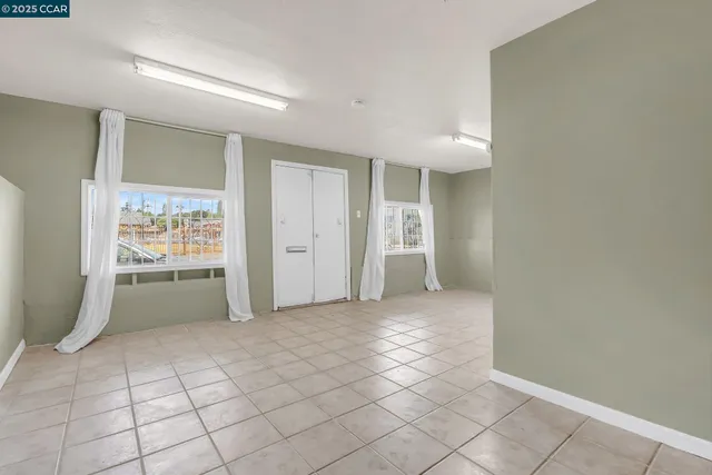 a view of an empty room and a bathroom