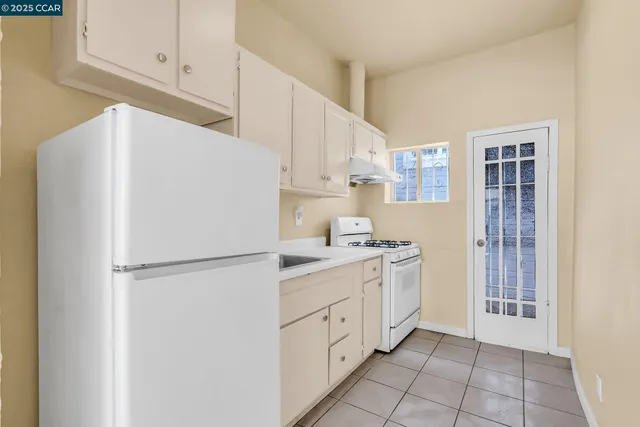 a kitchen with appliances cabinets and a sink