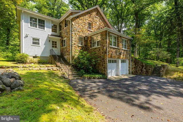 a view of a house with a big yard and large trees
