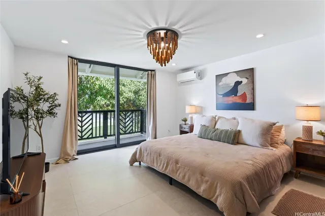 a bedroom with a large bed and a chandelier