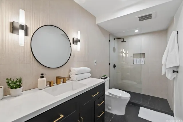 a bathroom with a toilet a sink and a mirror