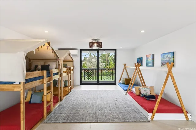 a view of an empty room with wooden floor and windows