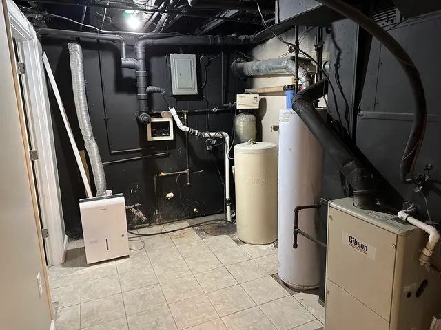 a view of storage and utility room with refrigerator