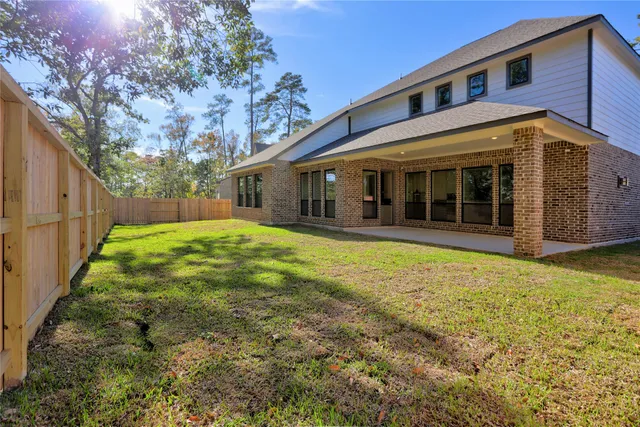 an aerial view of a house with a yard basket ball court and outdoor seating
