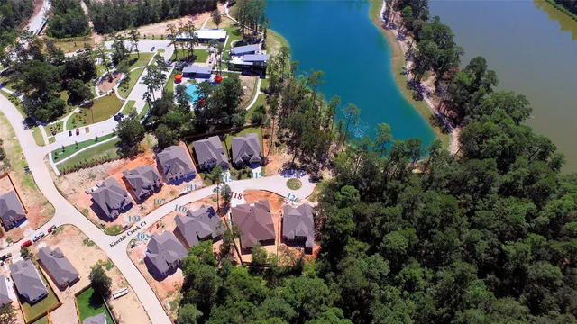 an aerial view of a house with a garden and lake view