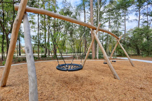 a view of outdoor space with playground and green space