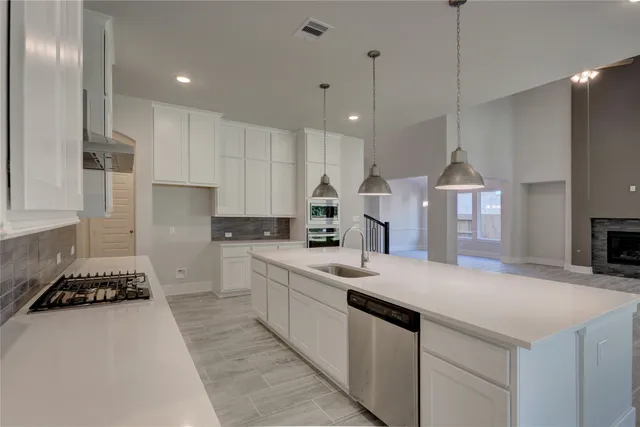 a kitchen with a sink stove and refrigerator