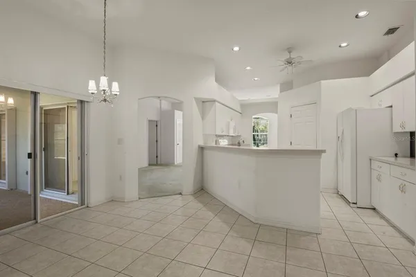 a view of kitchen with refrigerator and window