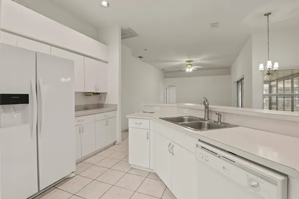 a kitchen with appliances cabinets and a sink