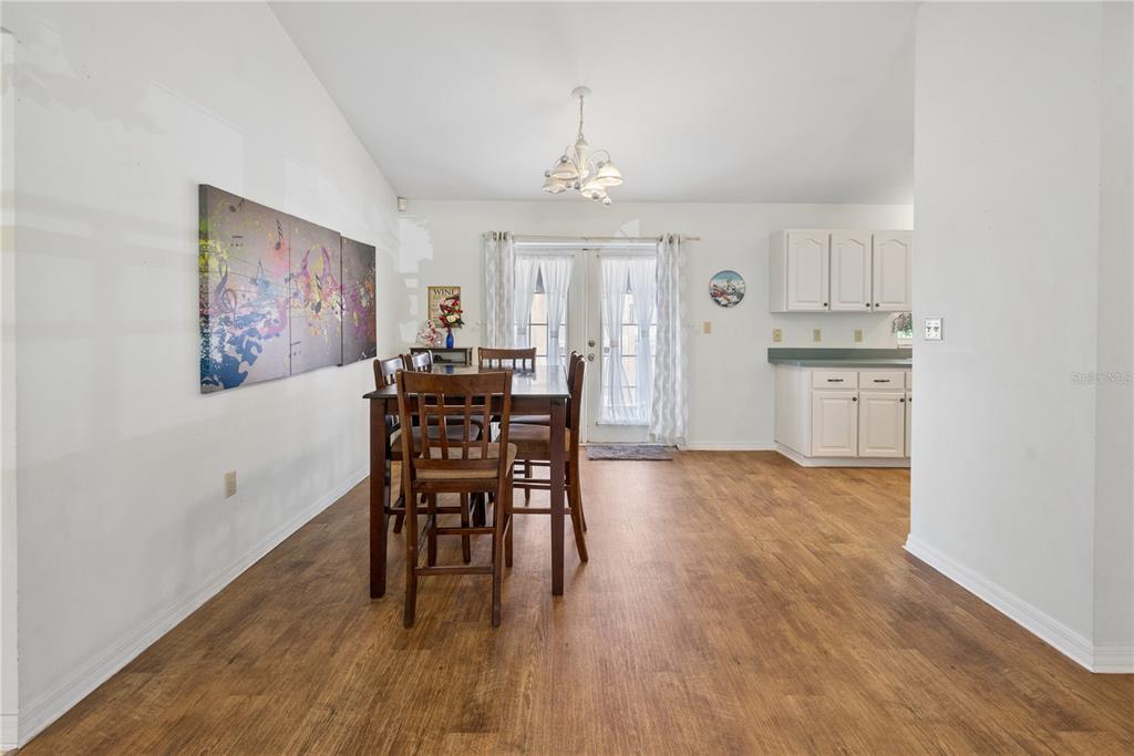 1750 Southwest 15th Street Bell, FL 32619 - Photo 7 of 34 a view of a dining room with furniture window and wooden floor
