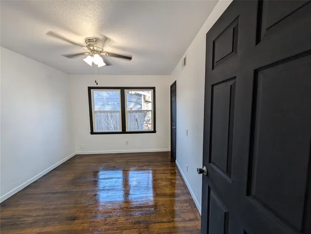 a kitchen with granite countertop white cabinets and black appliances