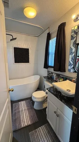 a bathroom with a toilet and a shower