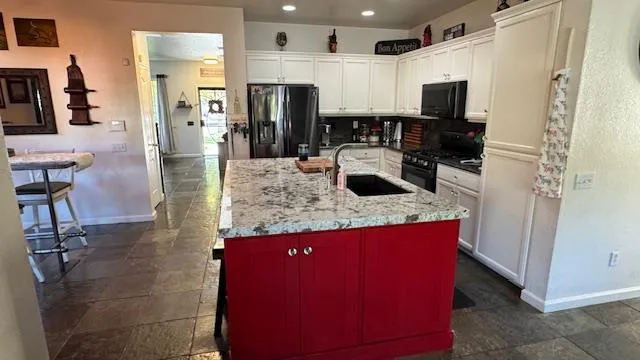 a kitchen with stainless steel appliances a stove a refrigerator and a microwave