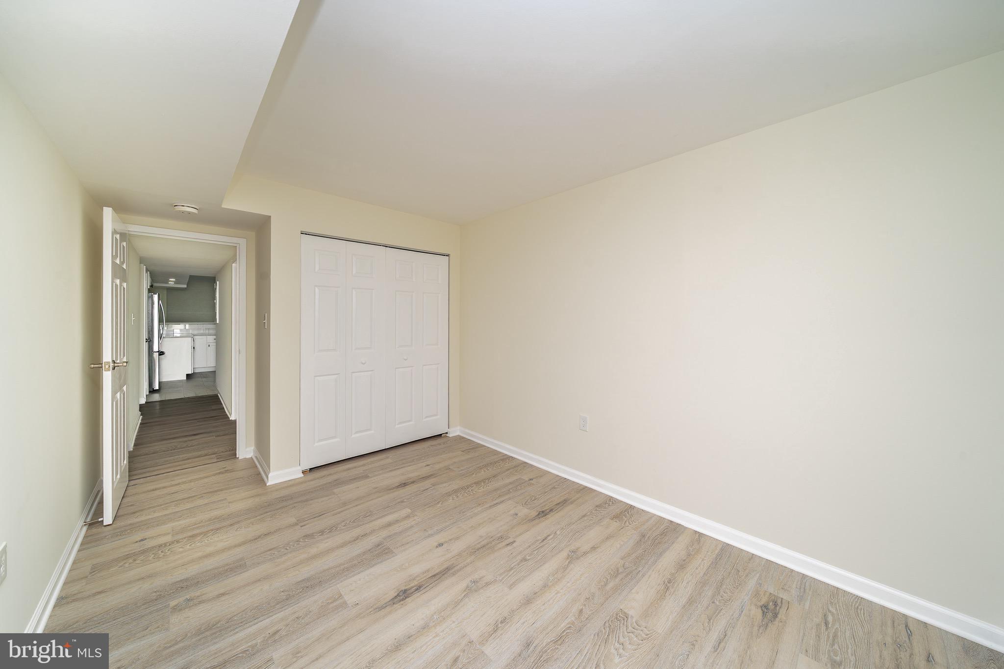 9910 Walker House Road, Unit 99104 Gaithersburg, MD 20886 - Photo 25 of 32 a view of an empty room and wooden floor