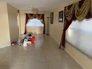 a view of a hallway with a couch and chandelier