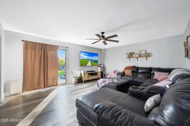 a living room with furniture a fireplace and a window