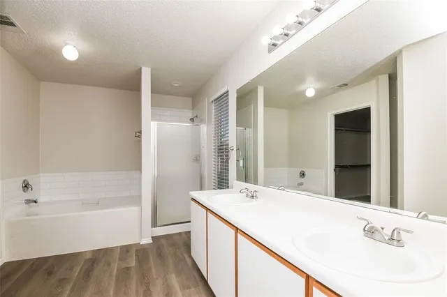 a bathroom with a tub sink and mirror