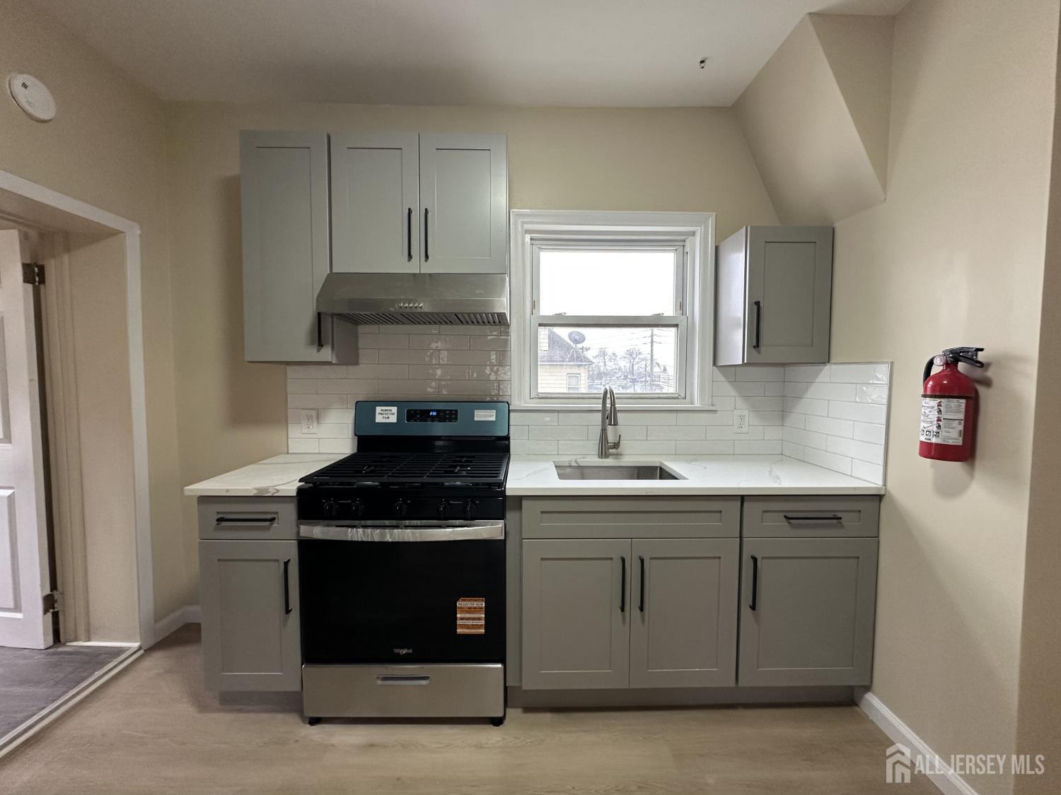618 Carlock Avenue Perth Amboy, NJ 08861 - Photo 6 of 9 a kitchen with a sink and a stove