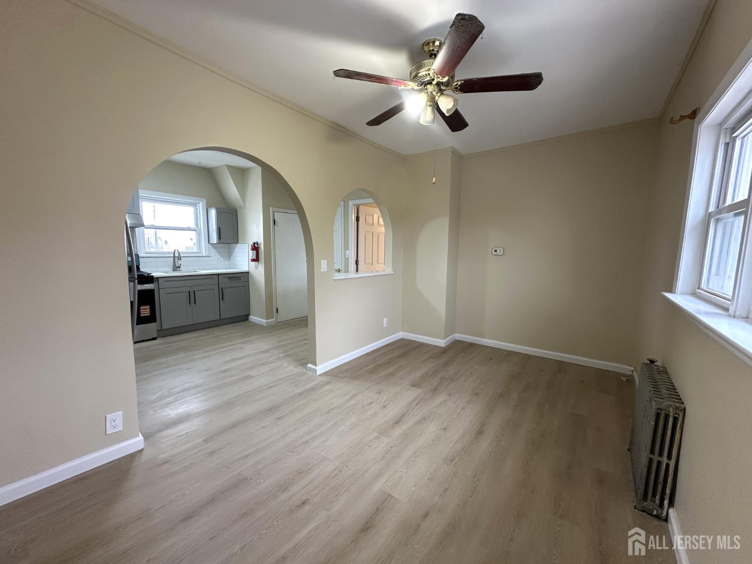 618 Carlock Avenue Perth Amboy, NJ 08861 - Photo 8 of 9 wooden floor in an empty room with a window