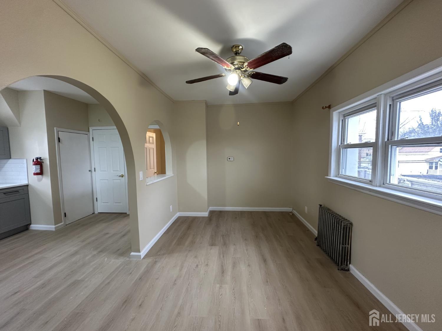 618 Carlock Avenue Perth Amboy, NJ 08861 - Photo 9 of 9 wooden floor in an empty room with a window
