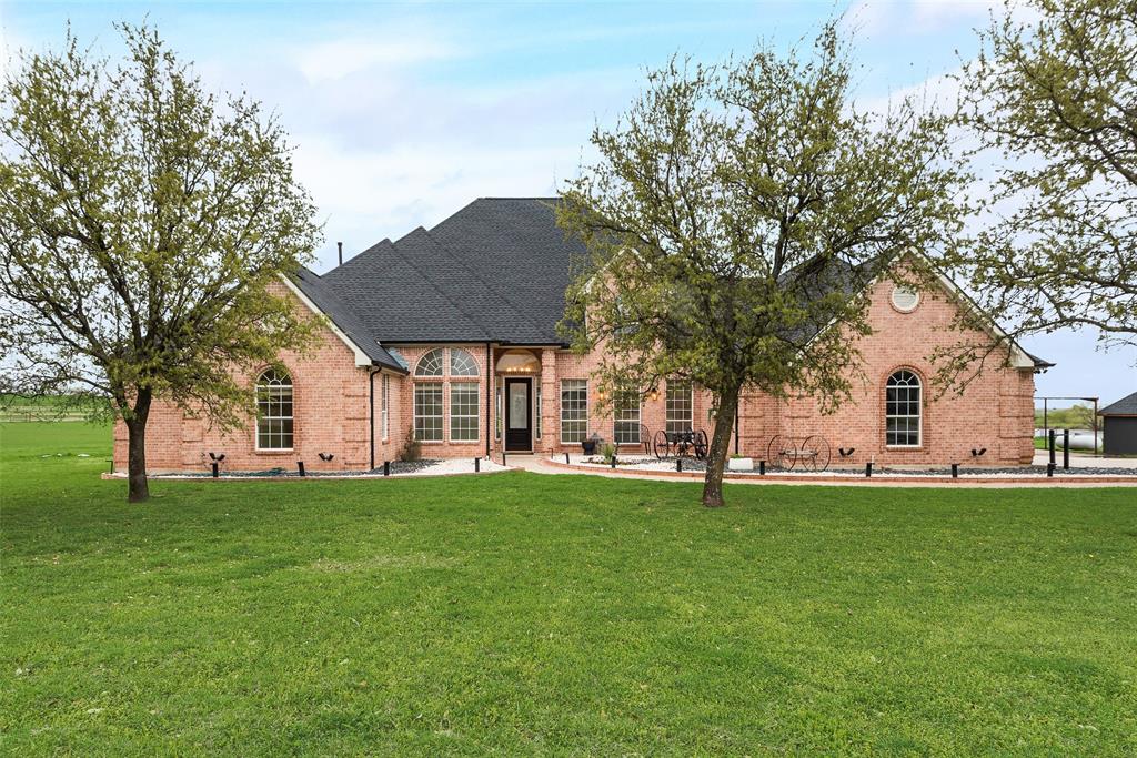 6083 Milam Ridge Denton, TX 76266 - Photo 1 of 1 Front of property featuring roof with shingles, brick siding, and a yard