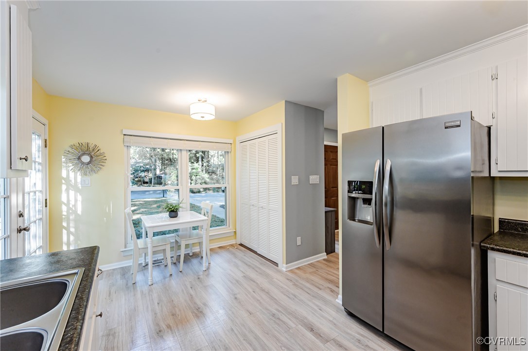 3100 3 Bridges Road Midlothian, VA 23112 - Photo 18 of 48 a kitchen with a table chairs refrigerator and wooden floor