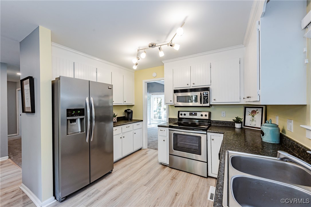 3100 3 Bridges Road Midlothian, VA 23112 - Photo 19 of 48 a kitchen with stainless steel appliances granite countertop a refrigerator a sink dishwasher a stove and a refrigerator with wooden floor