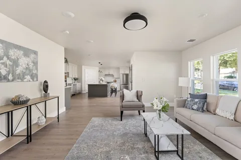 a living room with furniture and wooden floor