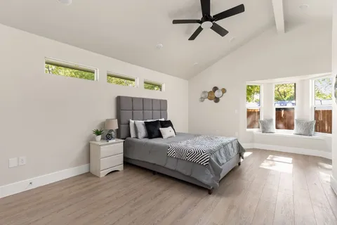 a bedroom with a bed and wooden floor