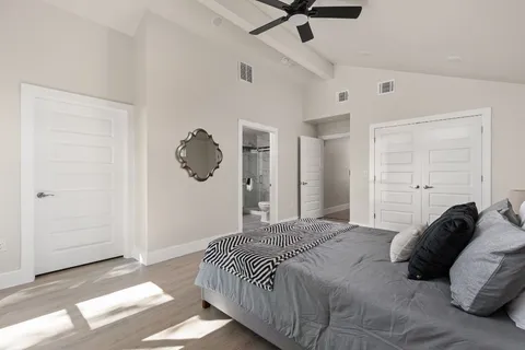 a bedroom with a bed and a chandelier