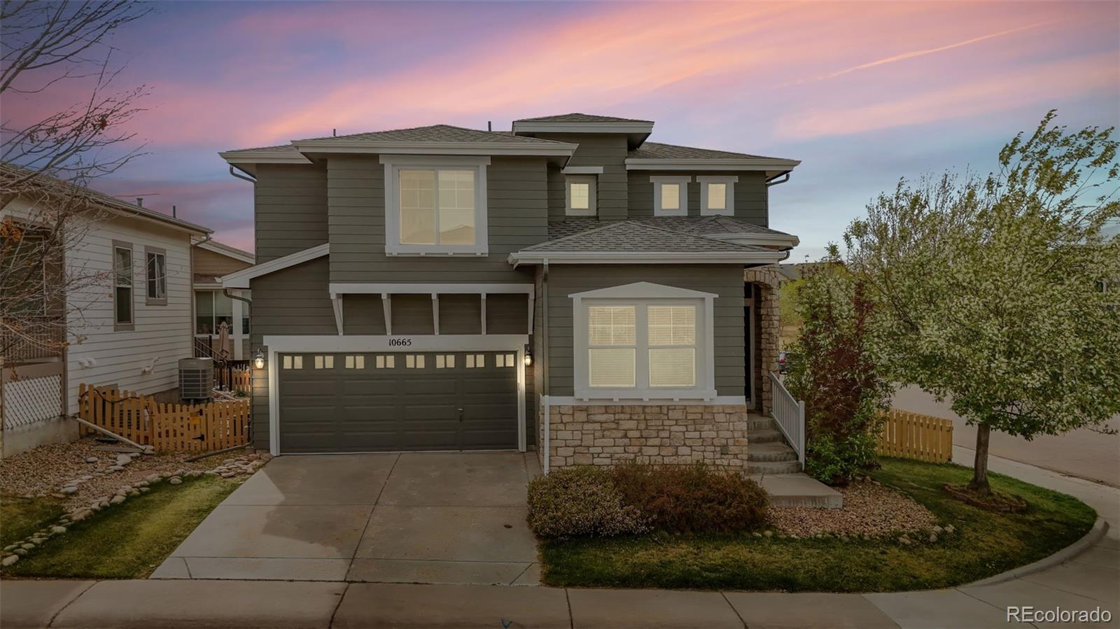 10665 Evondale Street Highlands Ranch, CO 80126 - Photo 1 of 45 a front view of a house with garden