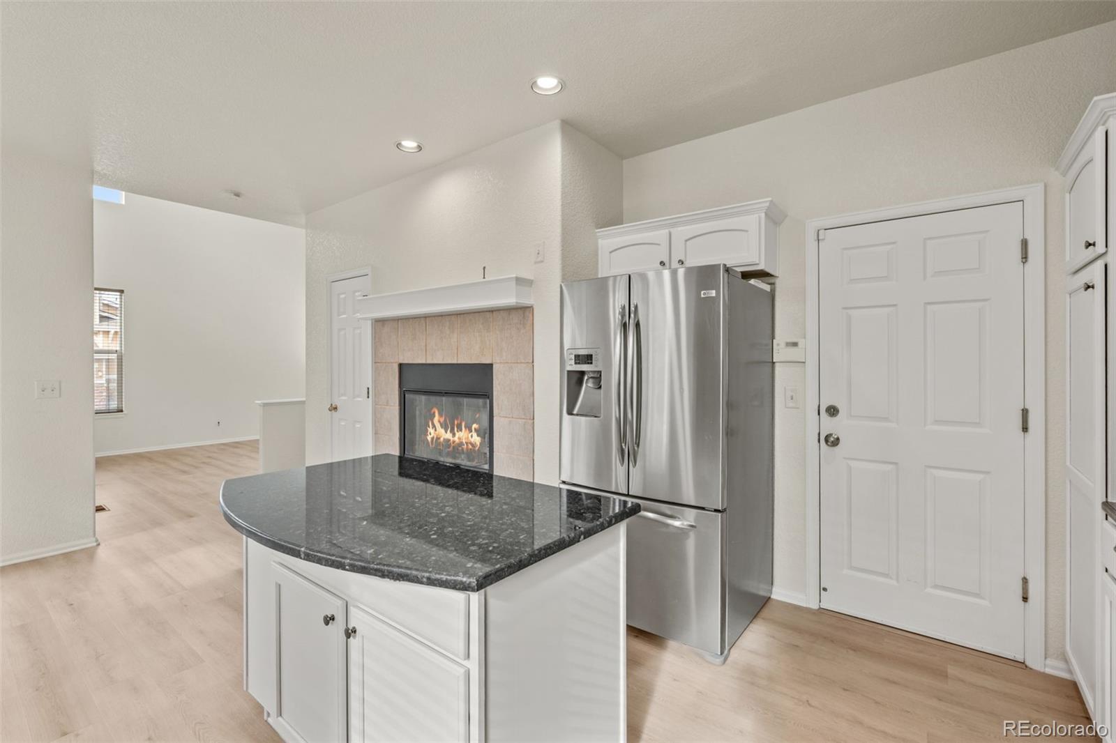 10665 Evondale Street Highlands Ranch, CO 80126 - Photo 13 of 45 a kitchen with stainless steel appliances granite countertop a refrigerator and a stove