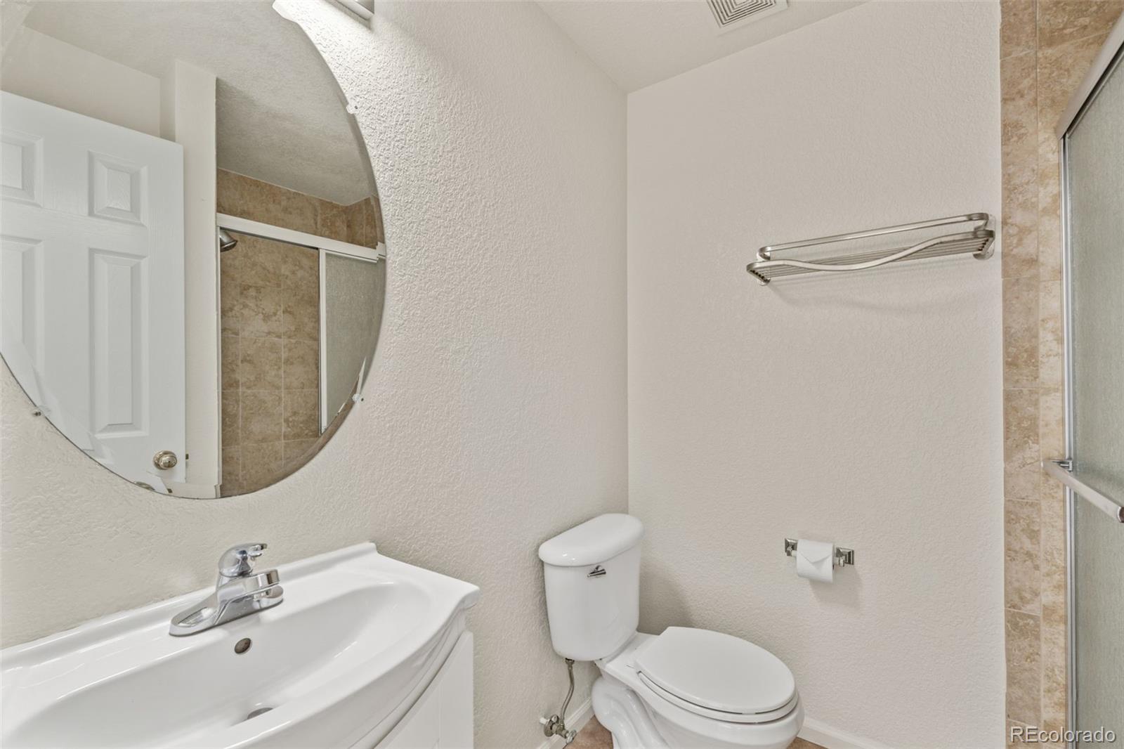 10665 Evondale Street Highlands Ranch, CO 80126 - Photo 19 of 45 a bathroom with a sink toilet and a mirror