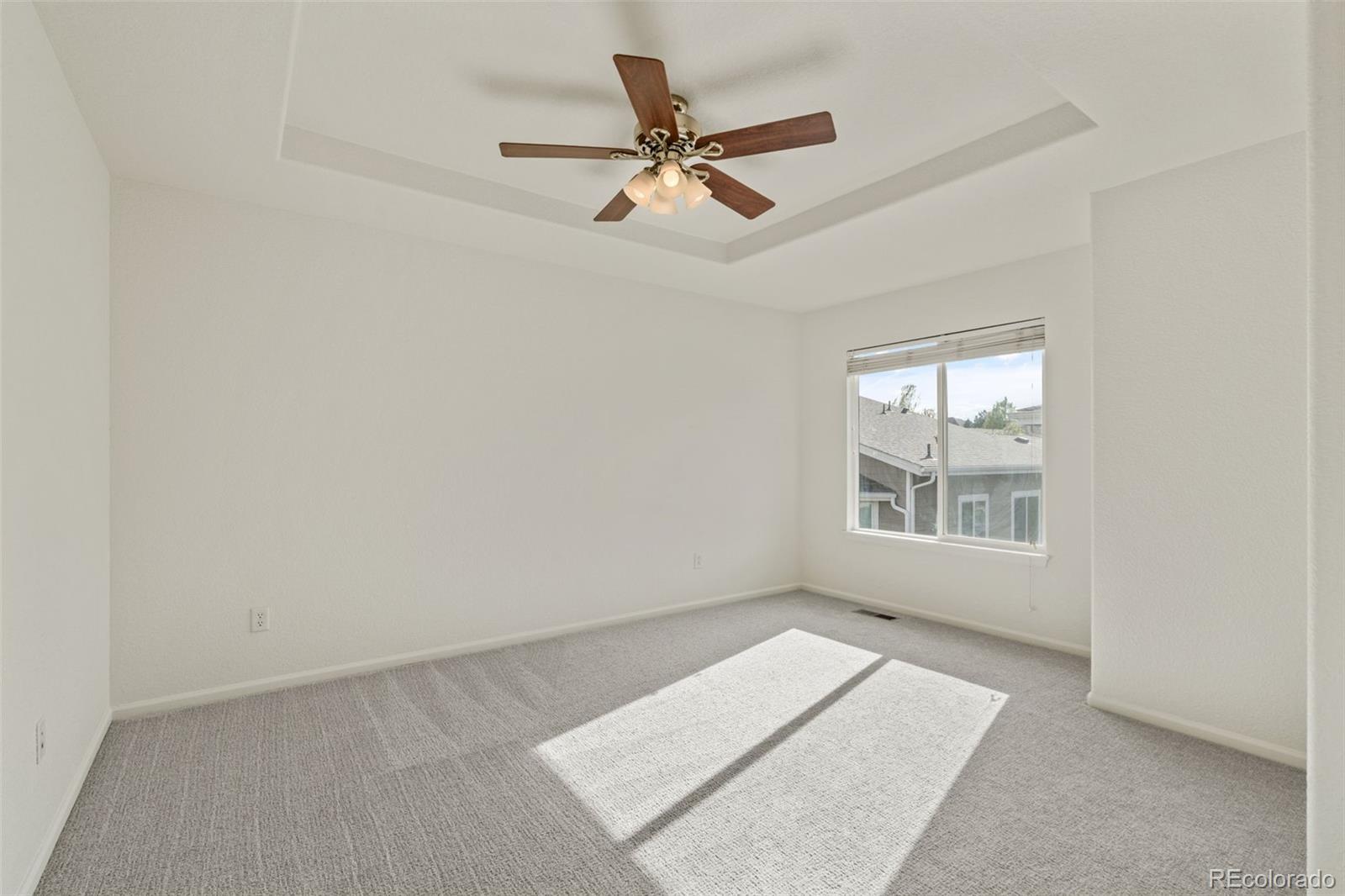 10665 Evondale Street Highlands Ranch, CO 80126 - Photo 20 of 45 an empty room with a ceiling fan and windows