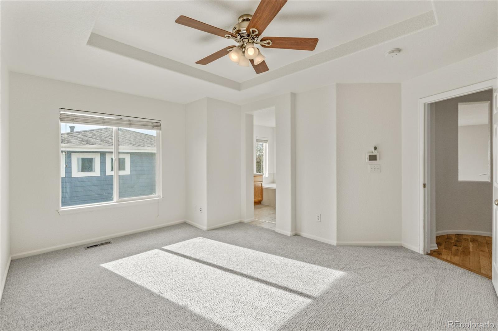 10665 Evondale Street Highlands Ranch, CO 80126 - Photo 22 of 45 a view of an empty room with a window and a ceiling fan
