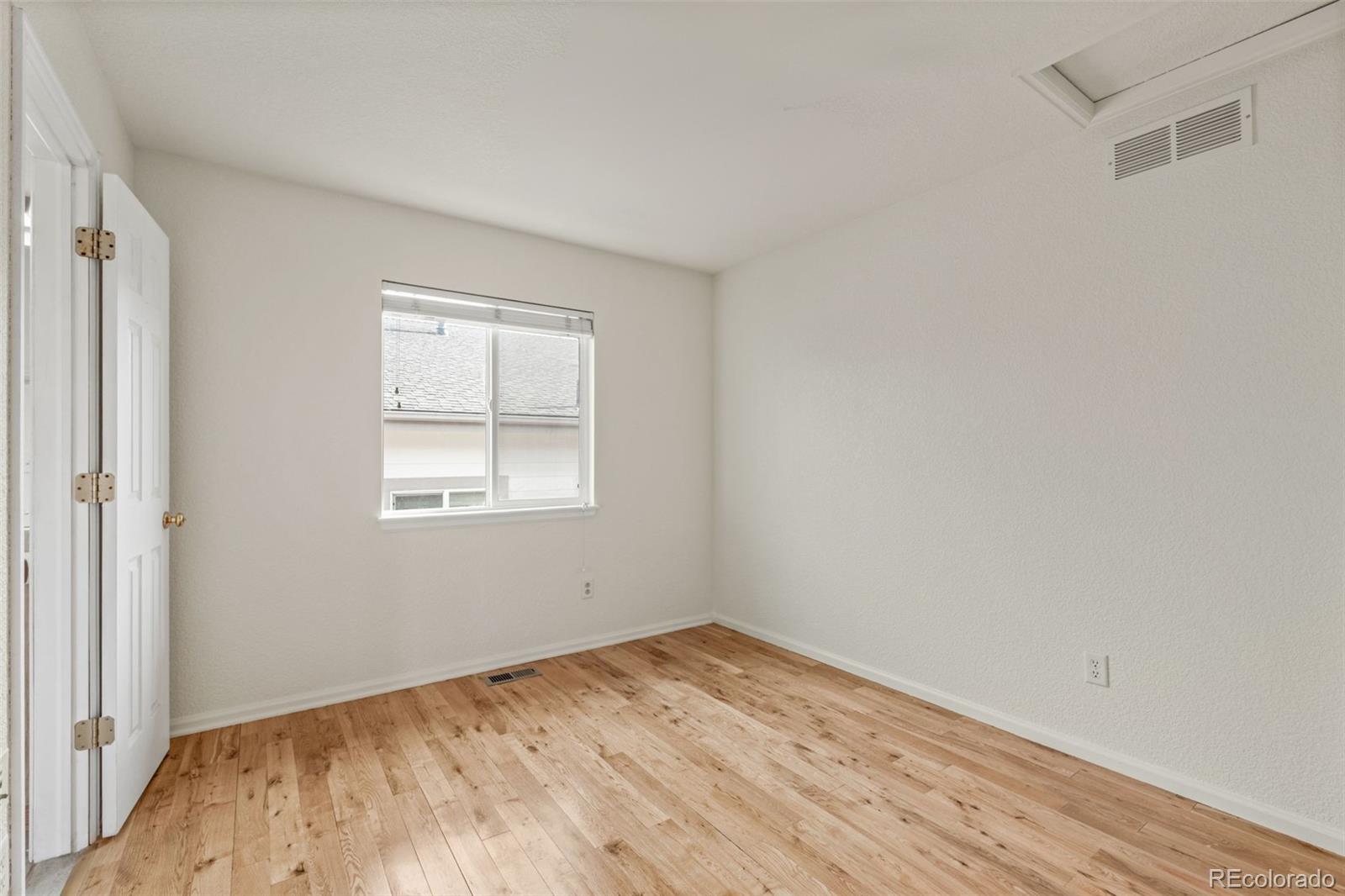 10665 Evondale Street Highlands Ranch, CO 80126 - Photo 30 of 45 a view of empty room with wooden floor and fan