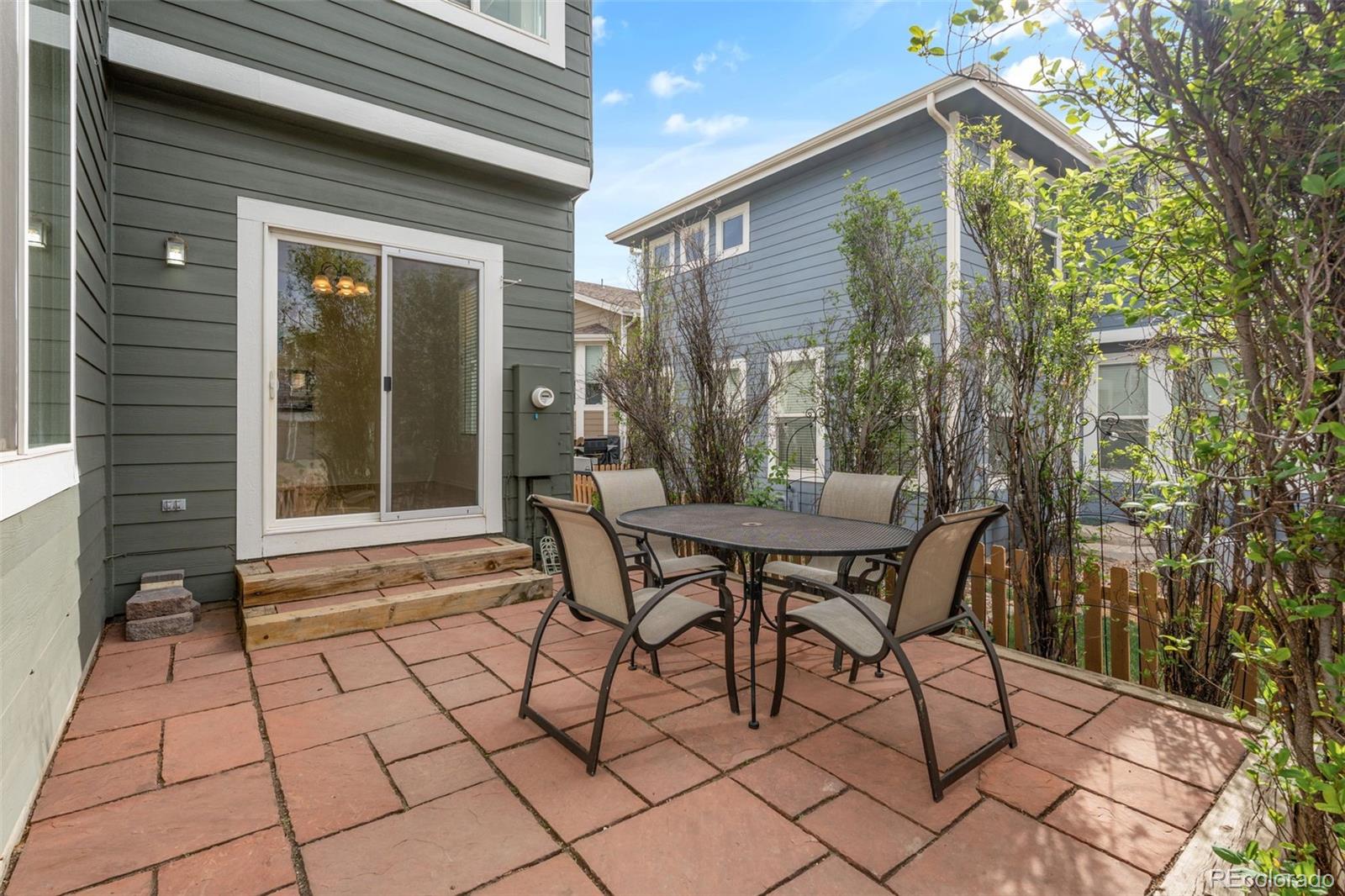 10665 Evondale Street Highlands Ranch, CO 80126 - Photo 36 of 45 a view of a patio with table and chairs and potted plants