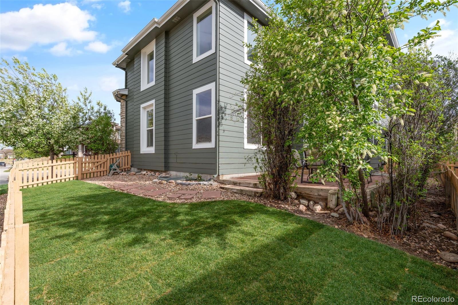 10665 Evondale Street Highlands Ranch, CO 80126 - Photo 38 of 45 a front view of a house with a garden and yard