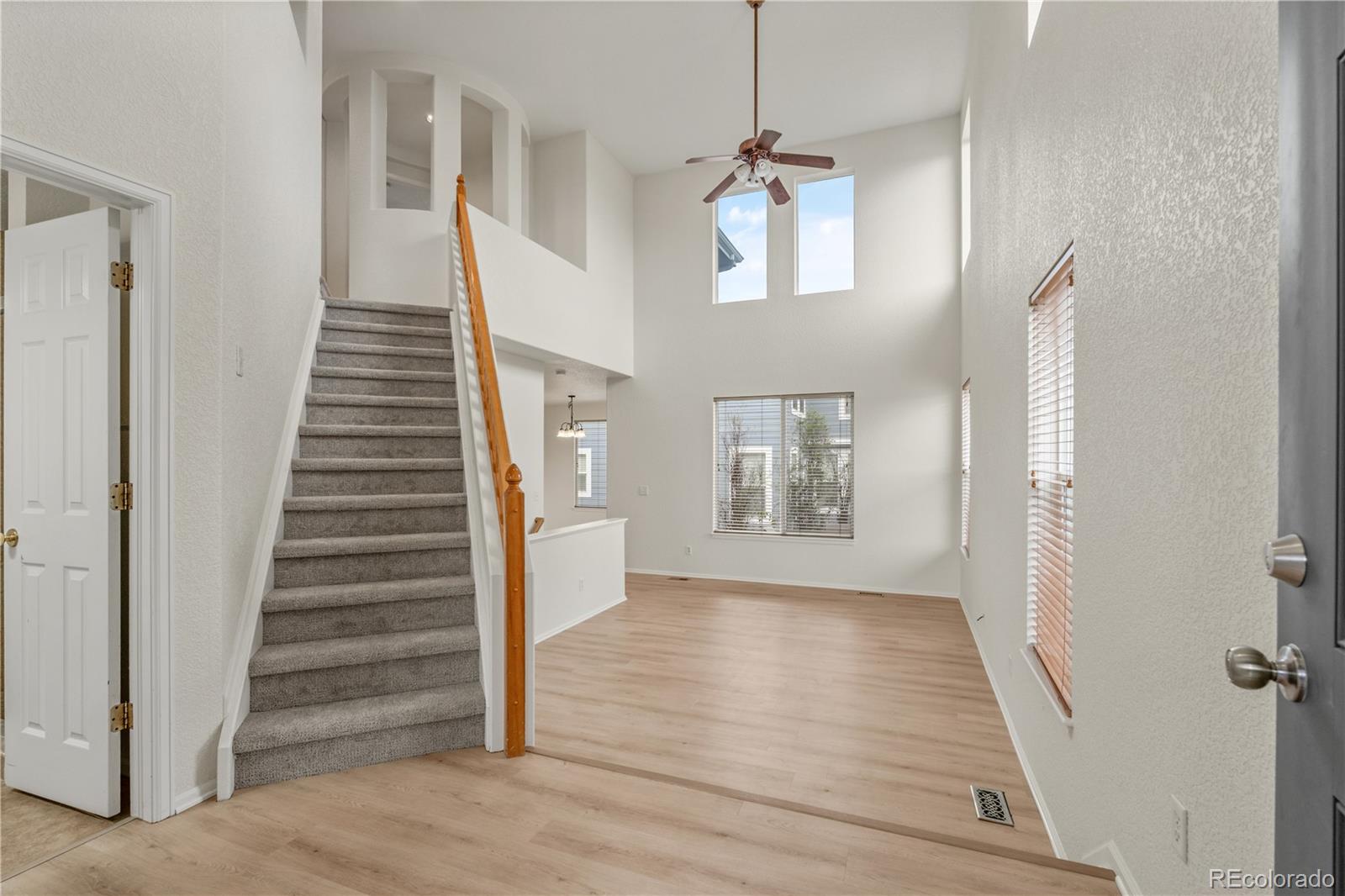 10665 Evondale Street Highlands Ranch, CO 80126 - Photo 4 of 45 a view of an entryway with wooden floor and staircase