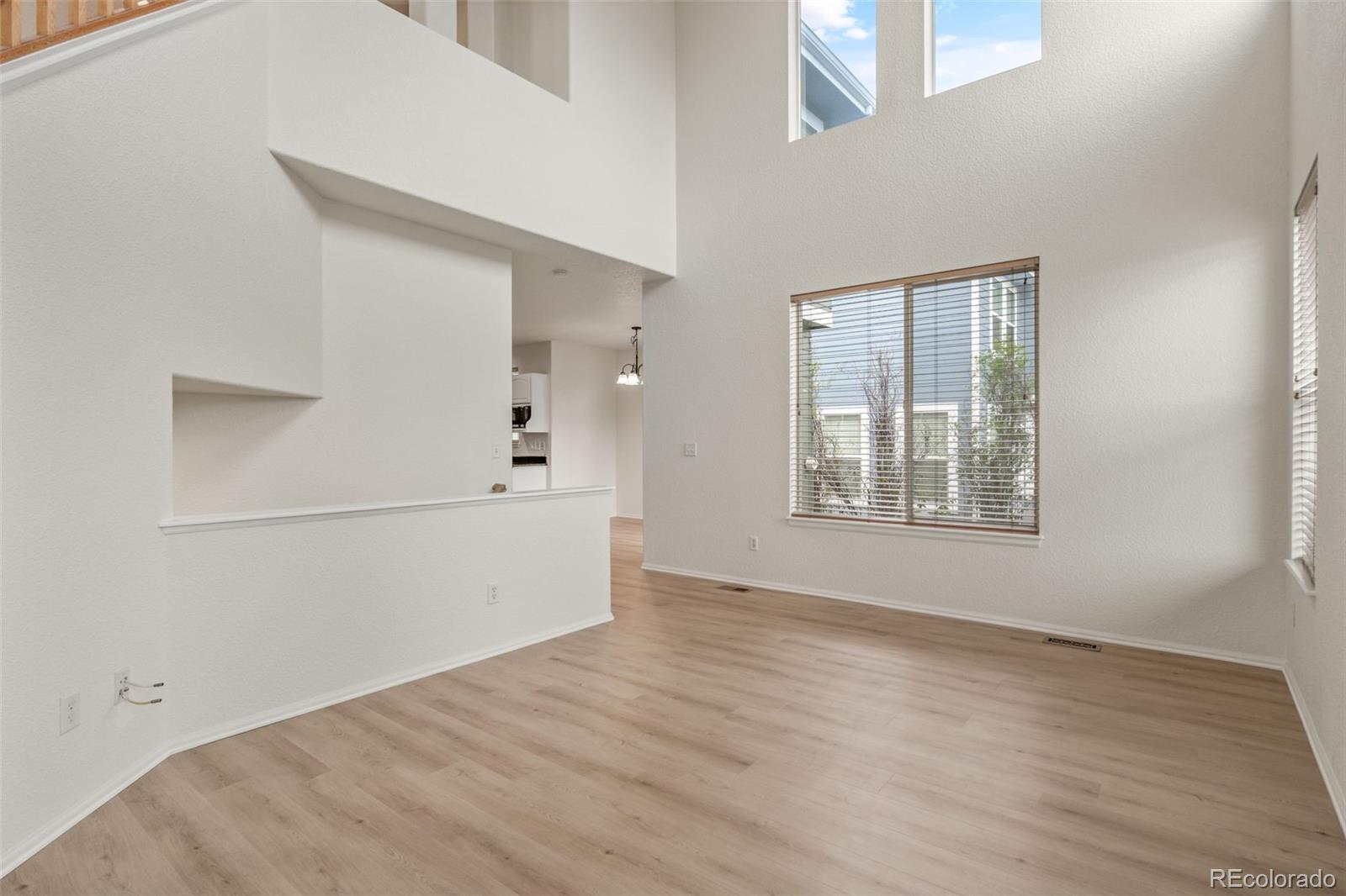 10665 Evondale Street Highlands Ranch, CO 80126 - Photo 6 of 45 wooden floor in an empty room with a window