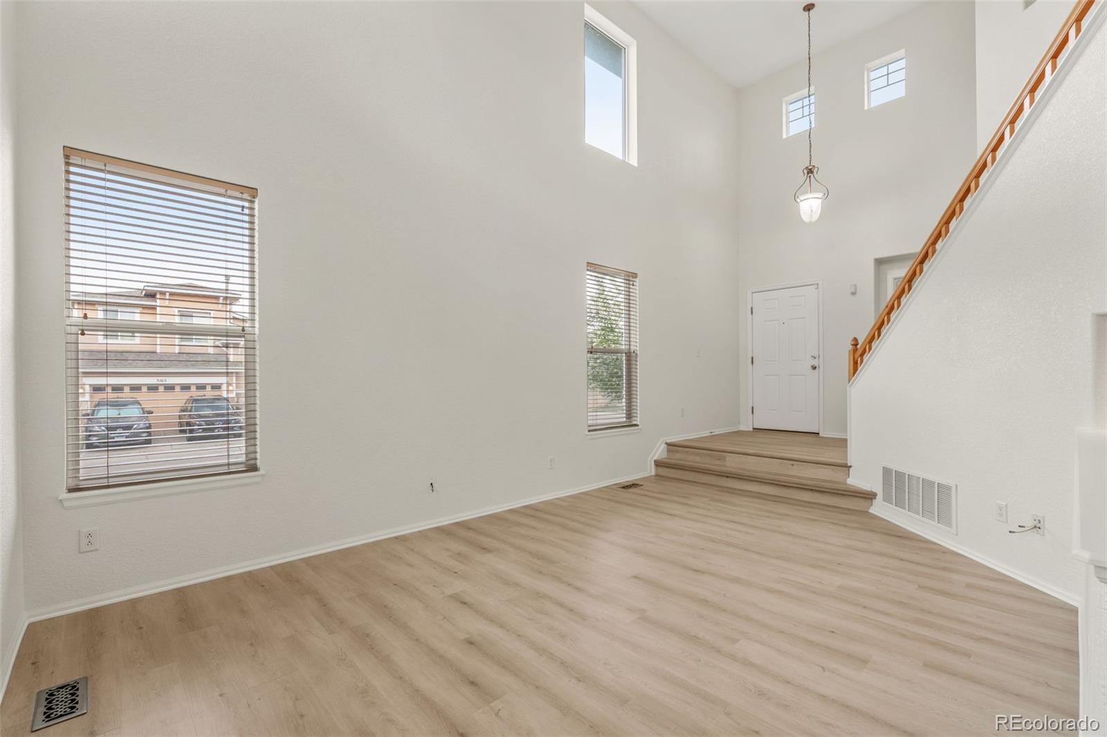 10665 Evondale Street Highlands Ranch, CO 80126 - Photo 8 of 45 an empty room with wooden floor and windows