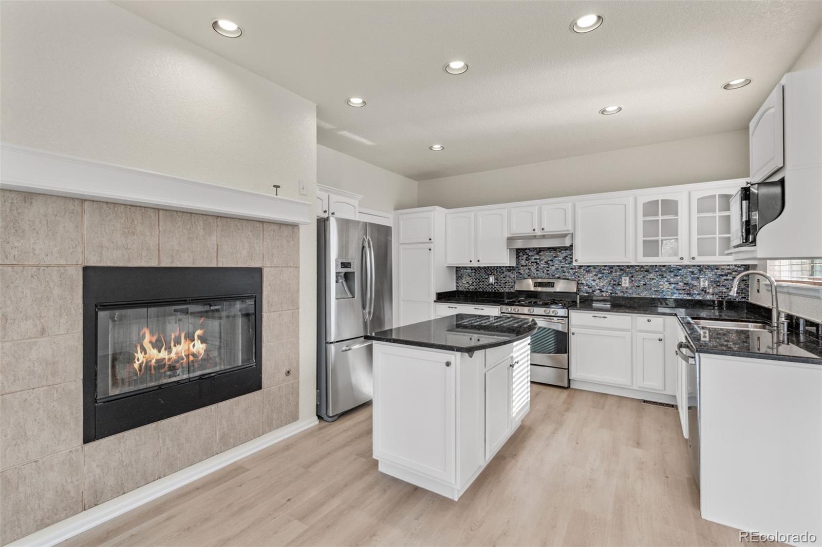10665 Evondale Street Highlands Ranch, CO 80126 - Photo 10 of 45 a kitchen with a stove top oven and refrigerator