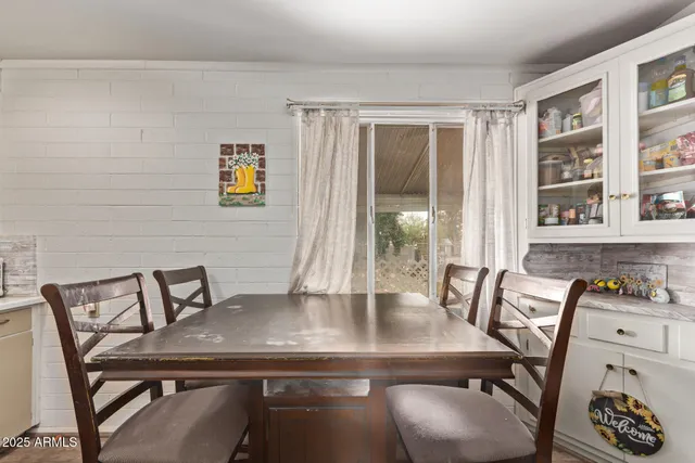a view of a workspace with furniture and window