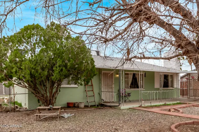 a view of a small house with a tree tree front of it