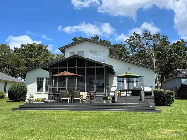 a front view of a house with a yard table and chairs