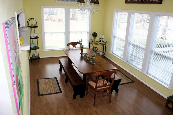 a view of a dining room with furniture and a window