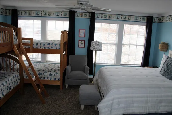 a bed sitting in a bedroom next to a window