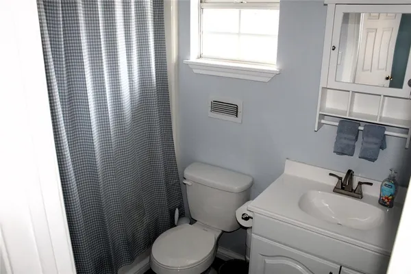 a white toilet sitting next to a bathroom sink