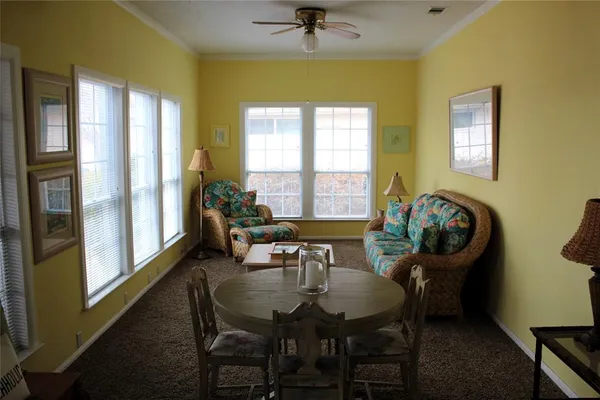 a view of a dining room with furniture and a window