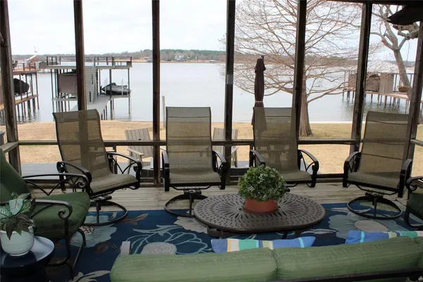 a living room with furniture and a floor to ceiling window
